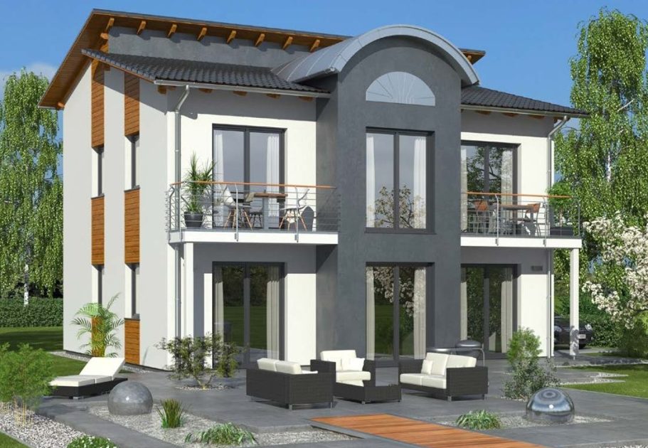 Drevo Fertigbau Moderne Doppelhaushälfte mit Balkon und Garten, umgeben von Bäumen.